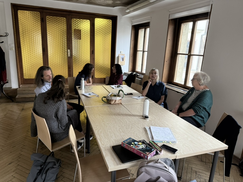 Participants around a table at the September meetup in Skautský institut.