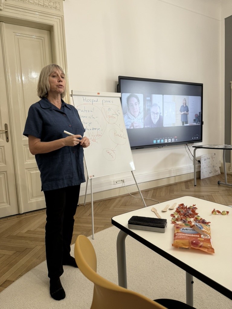A practical economics demonstration using sweets and wooden spoons.