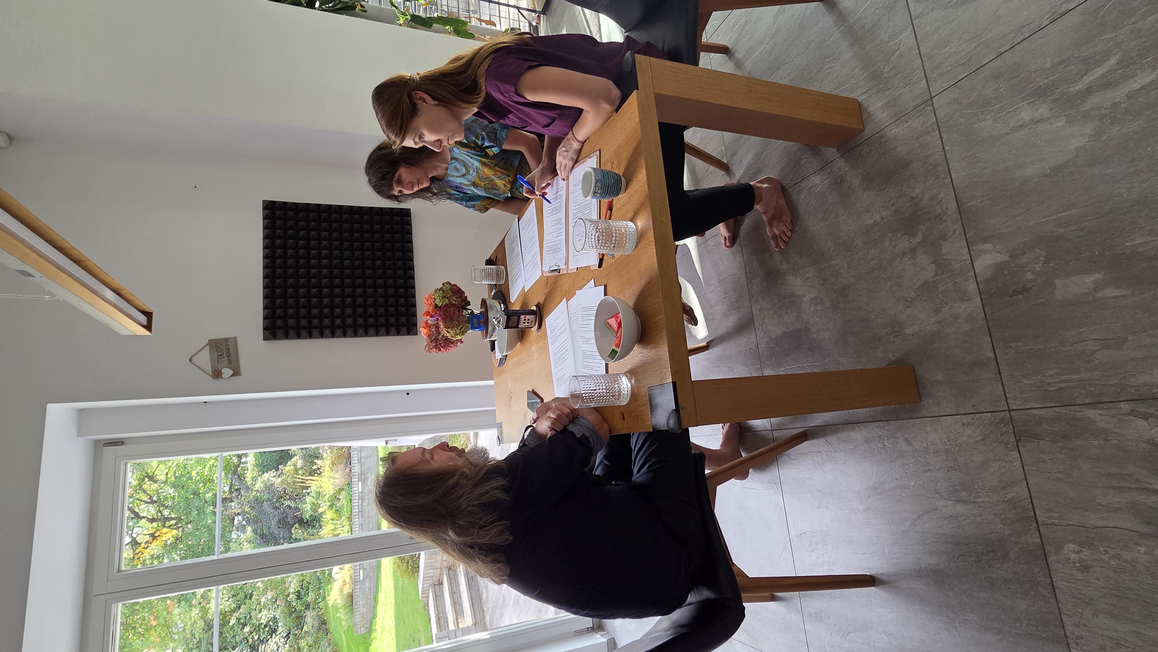 Tomáš, Taťána and Alice recording Being a mentor at school around a table.